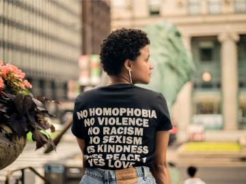Woman wearing a tshirt with anti discrimination wording