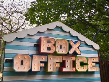 Blue and white striped shed with the words Box Office on it.
